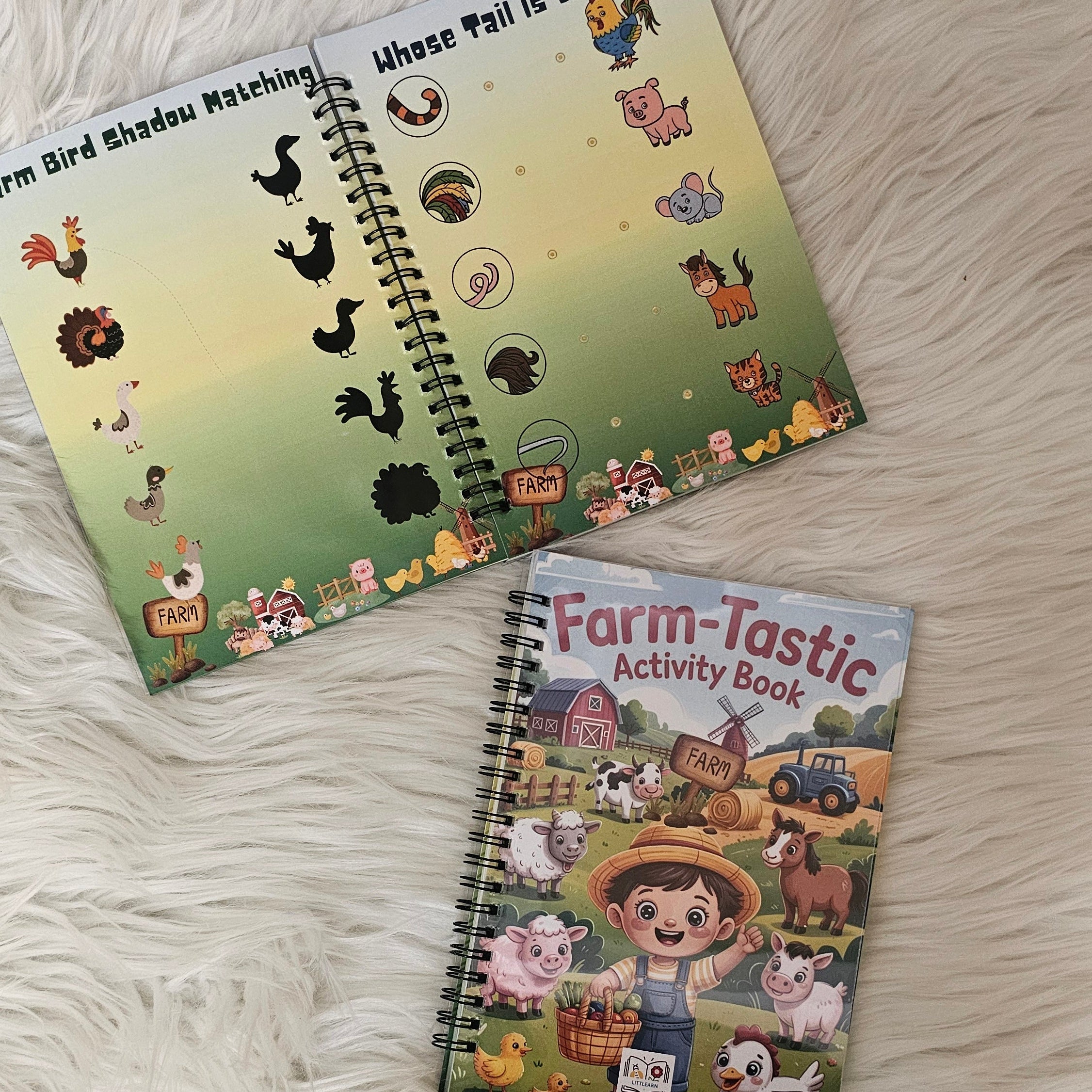 Two children's activity books on a fluffy white surface