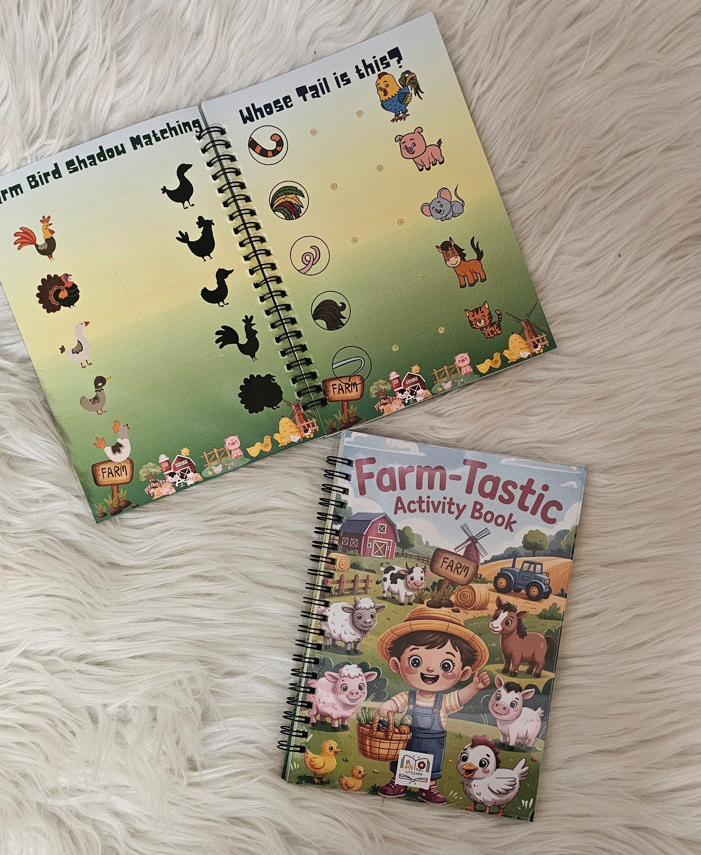 Two children's activity books on a fluffy white surface