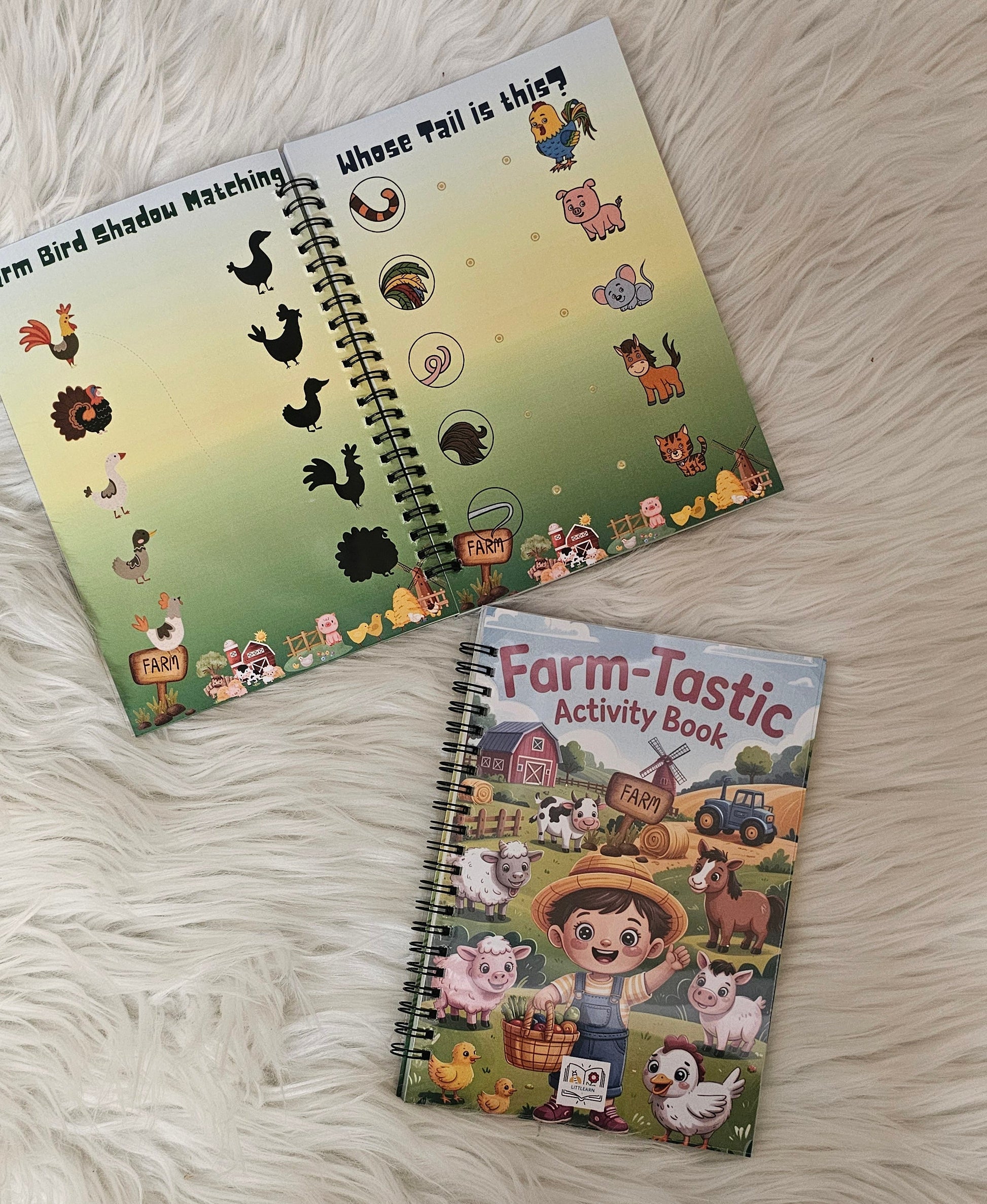 Two children's activity books on a fluffy white surface